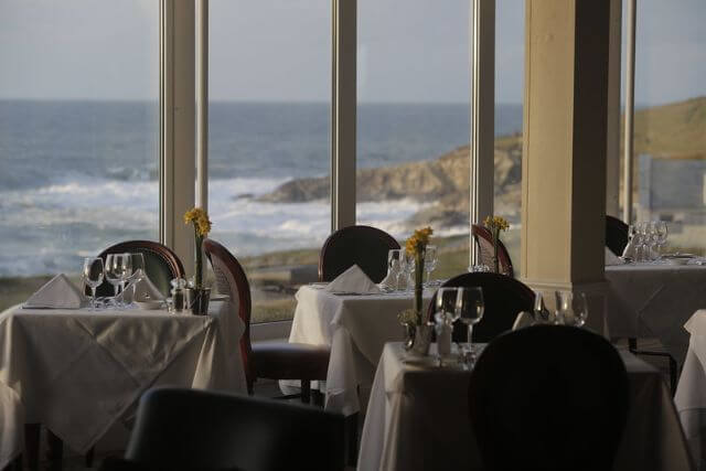 Restaurant with the coast in the background at Headland Hotel in Newquay, Cornwall.