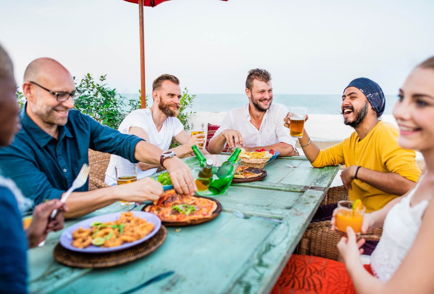 Group of adults at a restaurant by the coast.