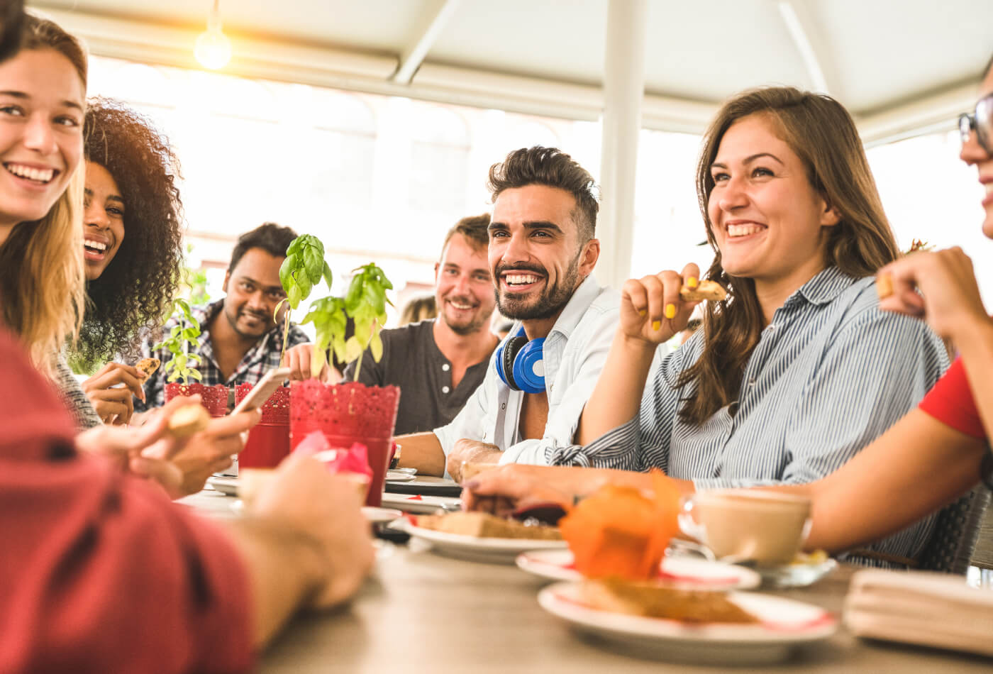 Friends around a table in a restaurant eating together.