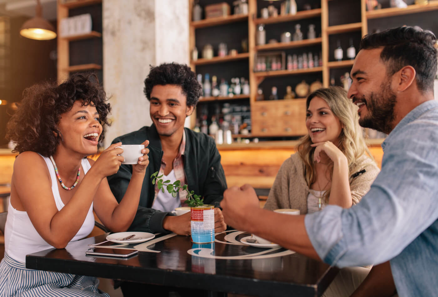 A group of friends in a restaurant drinking coffee.