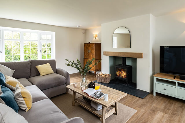 Samphire - dog friendly holiday let - living area with hard floors, tv and woodburner.